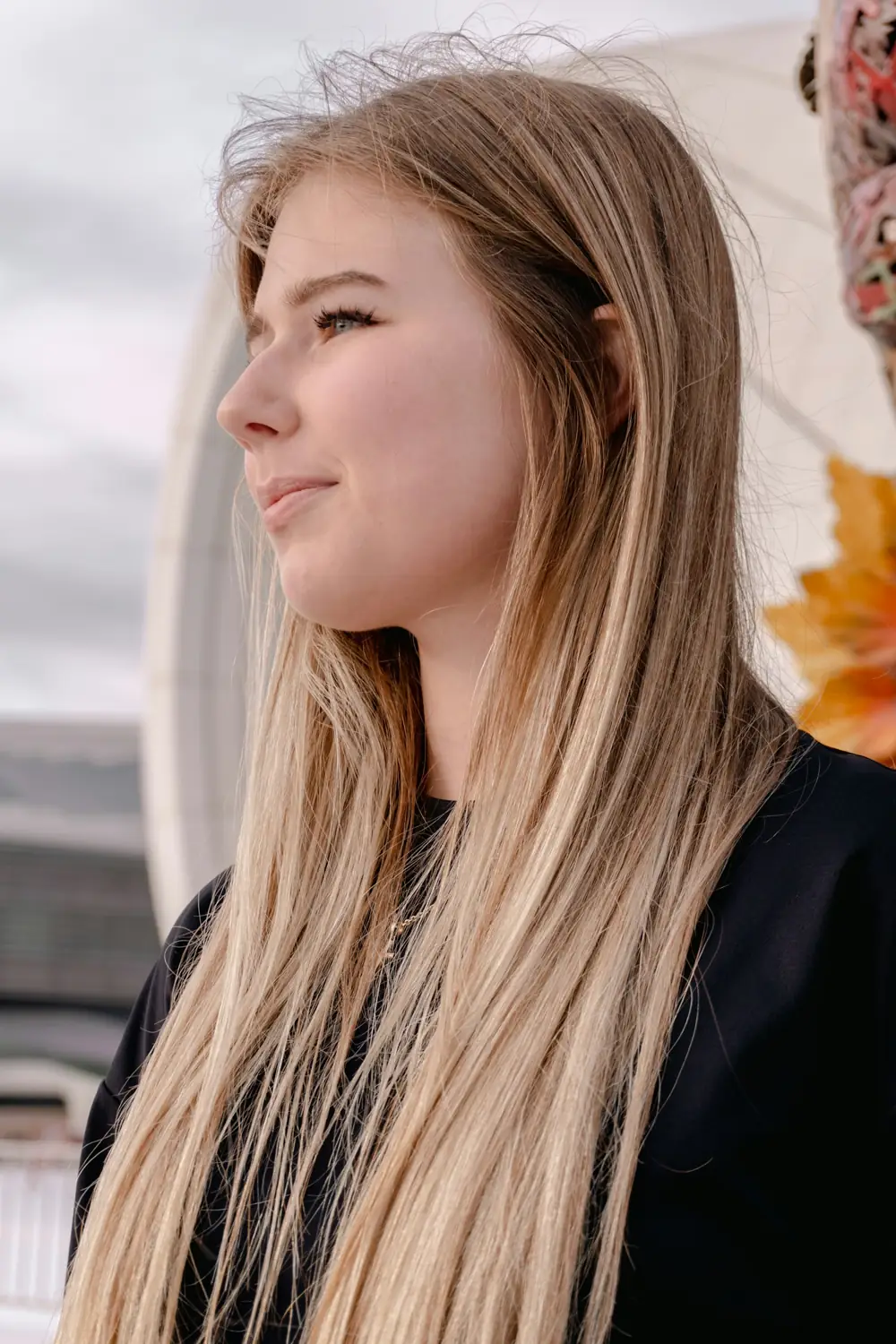 Young woman with long blonde hair looking away