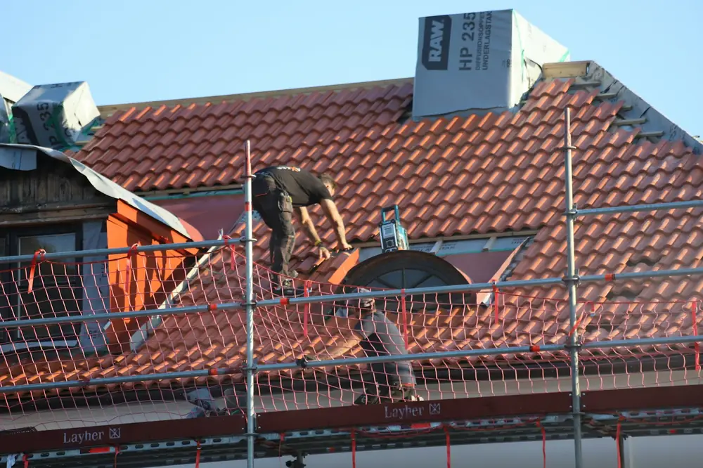 A man on a roof working on a roof